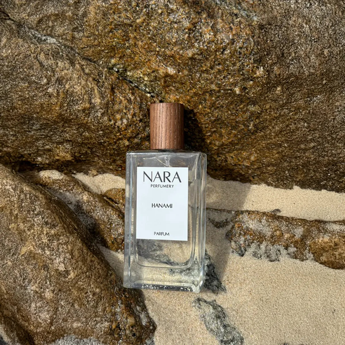 Nara Parfum bottle on a rocky surface