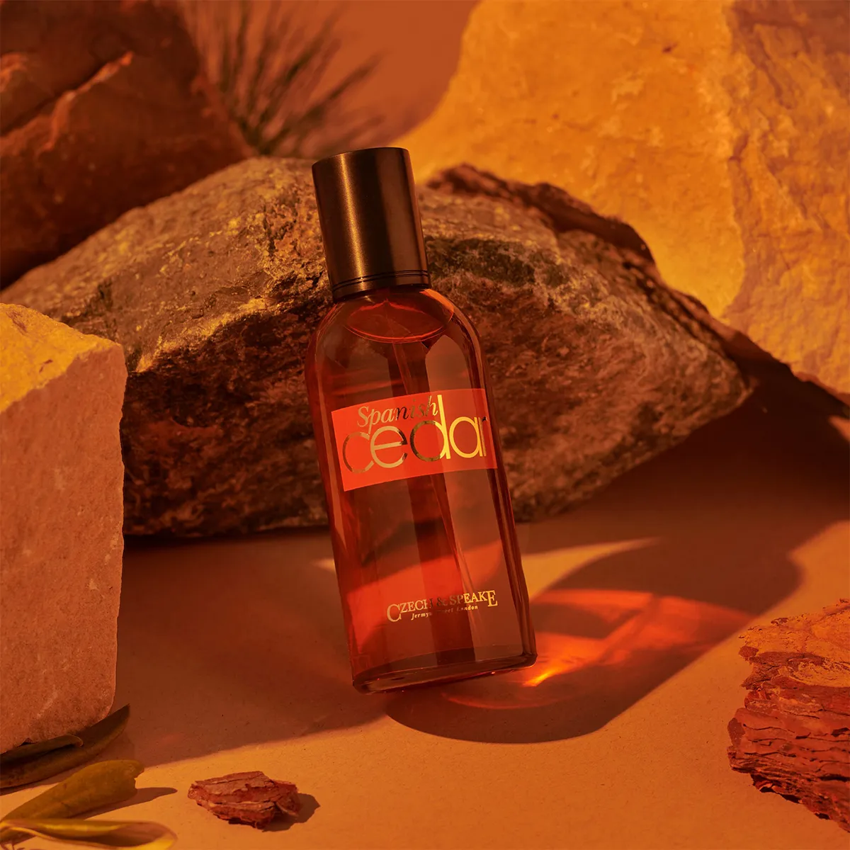 Perfume bottle labeled 'Seda' on a rocky surface with warm lighting
