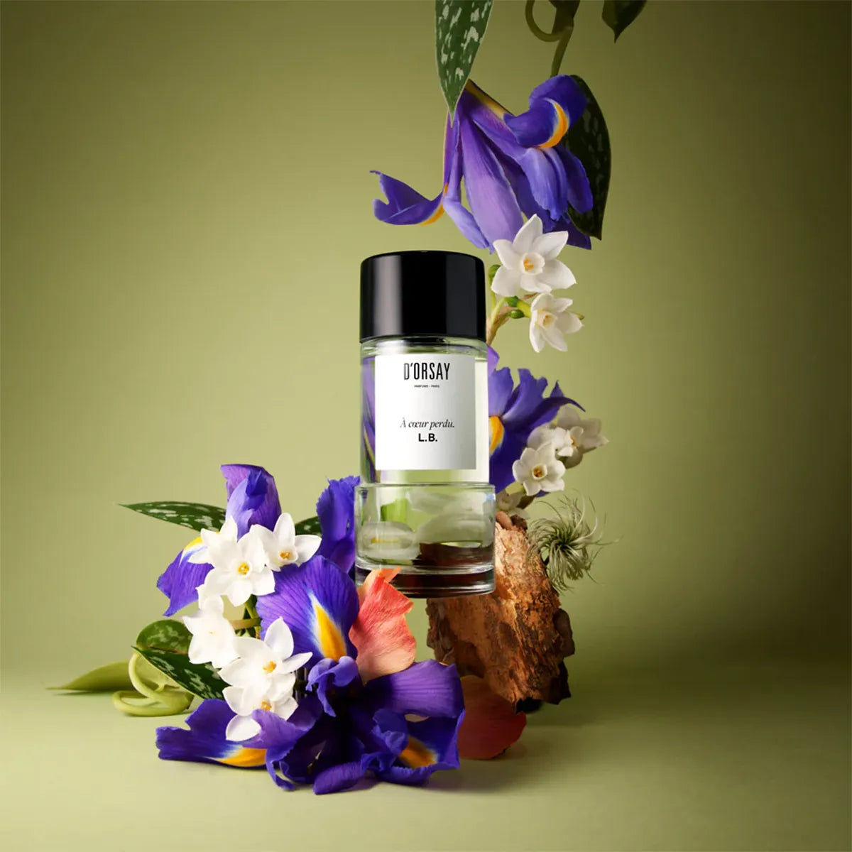 Bottle of Désiré perfume with flowers on a green background