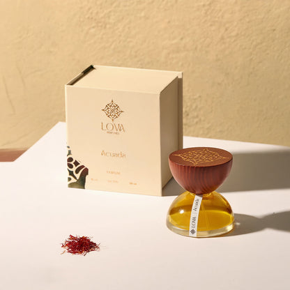 LOVA perfume bottle and packaging on a light surface with a beige background