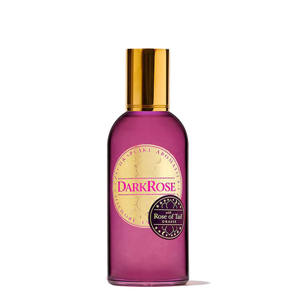 Purple bottle of Dark Rose perfume with gold cap on a white background