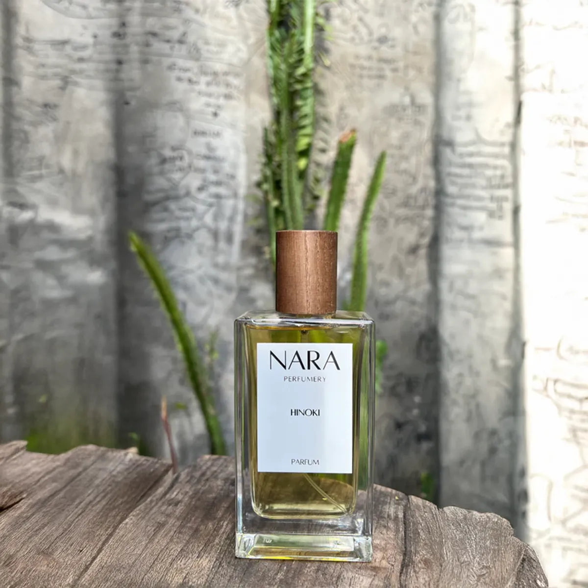 Nara Perfumery Hinoki perfume bottle on a wooden surface with a natural background