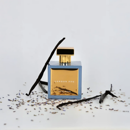 Perfume bottle labeled 'London Fog' with vanilla beans and lavender on a light background