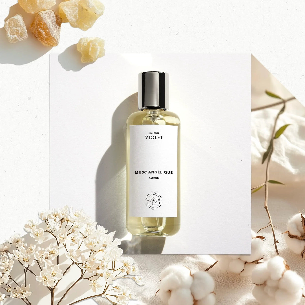 Musc Angélique by Maison Violet luxury perfume bottle placed on fabric with natural shadows
