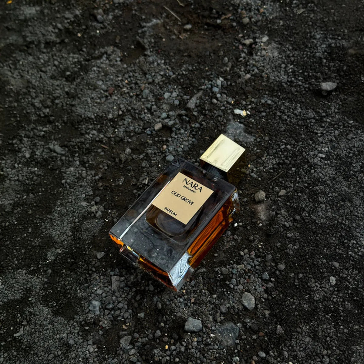 NARA Oud Grove perfume bottle on a dark textured surface