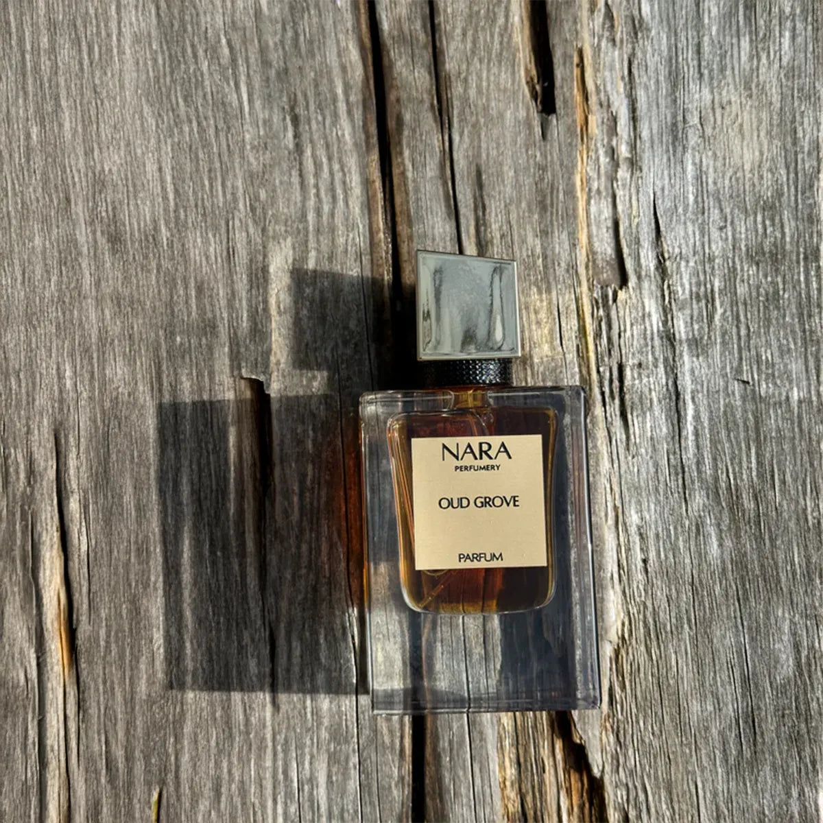Nara Old Grove perfume bottle on a wooden surface