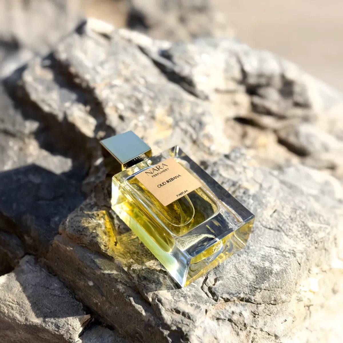 Perfume bottle labeled 'Nara' on a rock with a natural background