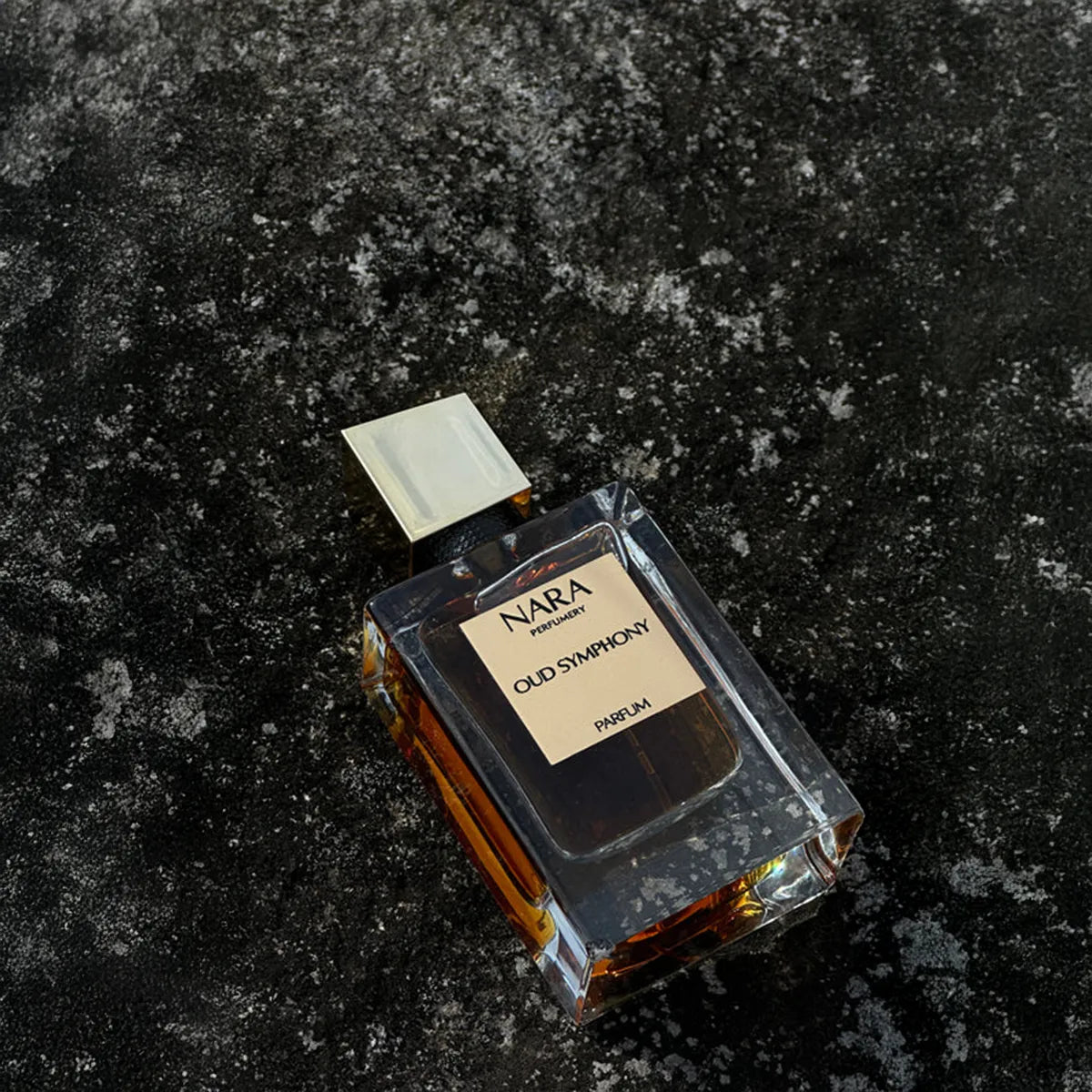 Perfume bottle labeled 'Nara Old Symphony' on a textured black surface