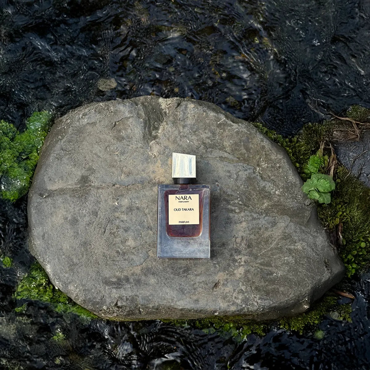 Nara Old Tobacco perfume bottle on a stone with a natural background
