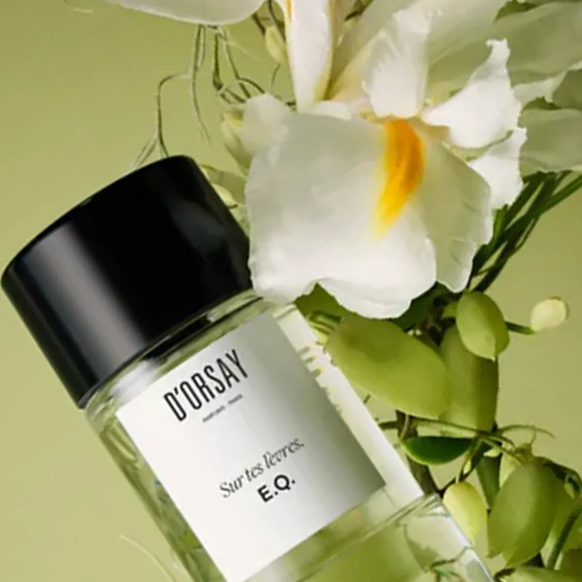 Perfume bottle labeled 'D'Orsay' with flowers in the background