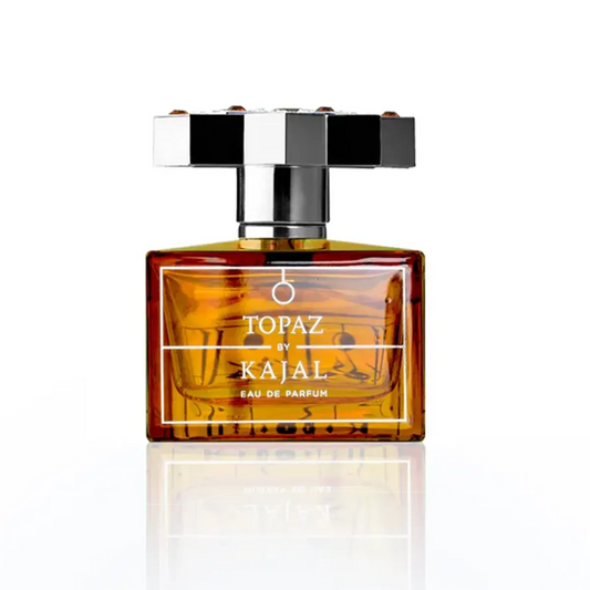 Perfume bottle labeled 'Topaz by Kajal' on a white background