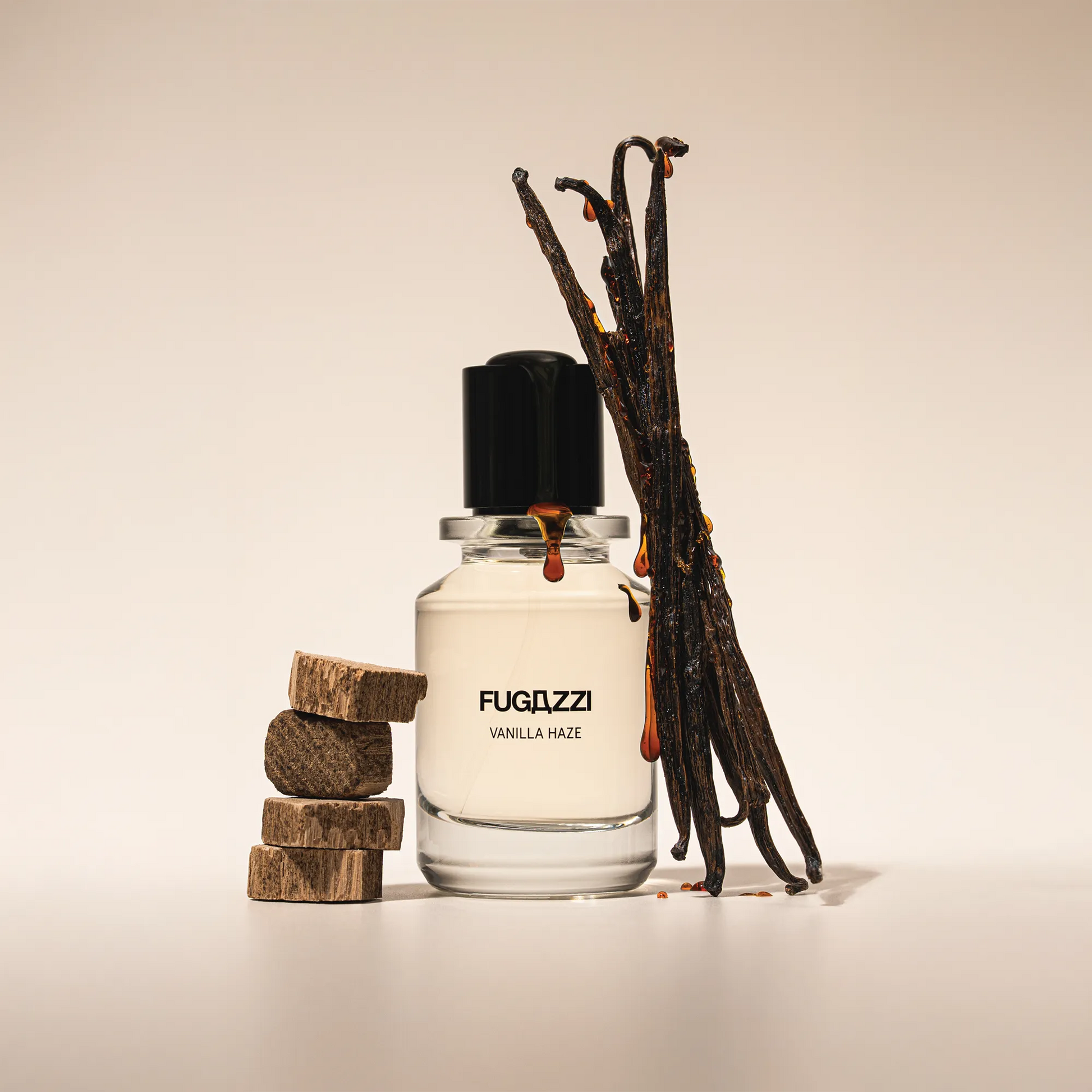 Fugazzi Vanilla Haze perfume bottle with vanilla beans and wooden elements on a beige background